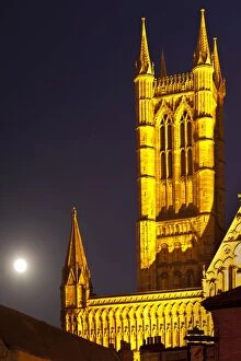 England, Lincolnshire, Lincoln. Full moon behind Lincoln Cathedral in the historic UK city of Lincoln