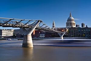 Images Dated 9th August 2011: England, London, St Pauls Cathedral. A boat passes below the London Millennium Bridge which links