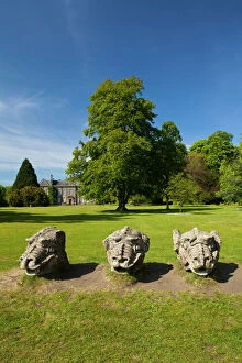 England. Northumberland, Wallington Hall. Carved stone dragon heads in the gardens of Wallington Hall