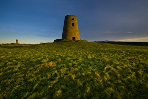 Northern County Gallery: England, Tyne & Wear, Cleadon Hills. The rising sun spotlights the old mill in Windmill Field