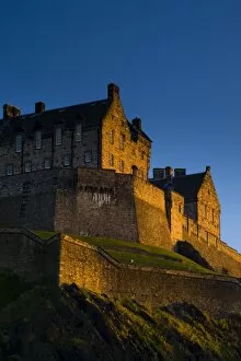 Trending: Scotland, Edinburgh, Edinburgh Castle. The last light of the setting sun illuminates Edinburgh