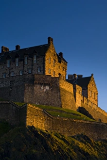 Trending: Scotland, Edinburgh, Edinburgh Castle. The last light of the setting sun illuminates Edinburgh