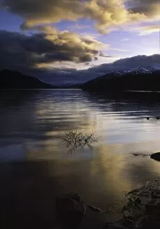 SCOTLAND, Scottish Highlands, Loch Laggan. A storm clears behind the peaks surrounding the still waters of